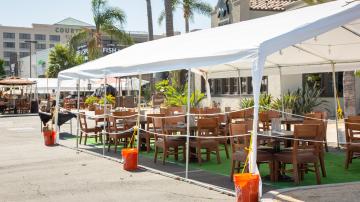 A view of an vacant outdoor tent patio seating area for a local El Torito restaurant, during the pandemic.