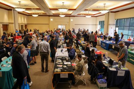 Overview of room with job seekers and employers during a Career Fair